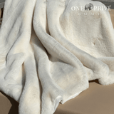 Indulge in the epitome of luxury with the One Preevay Faux Rabbit Fur Throw in Pure White. Inspired by the elegance of Fernando Botero and crafted from ultra-premium faux rabbit fur. Hypoallergenic, cruelty-free, and lined with elegant velvet for refined warmth and sophistication. 800gsm, 50x60 inches...outdoor