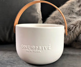 Discover the Grapefruit Neroli Perfumed Estate Candle from One Preevay. Handcrafted with premium essential oils and soy wax, it features a porcelain bowl with a silver-plated lid and leather strap. Enjoy the aromatic fusion of grapefruit and neroli. Order now to elevate your ambiance day or night.