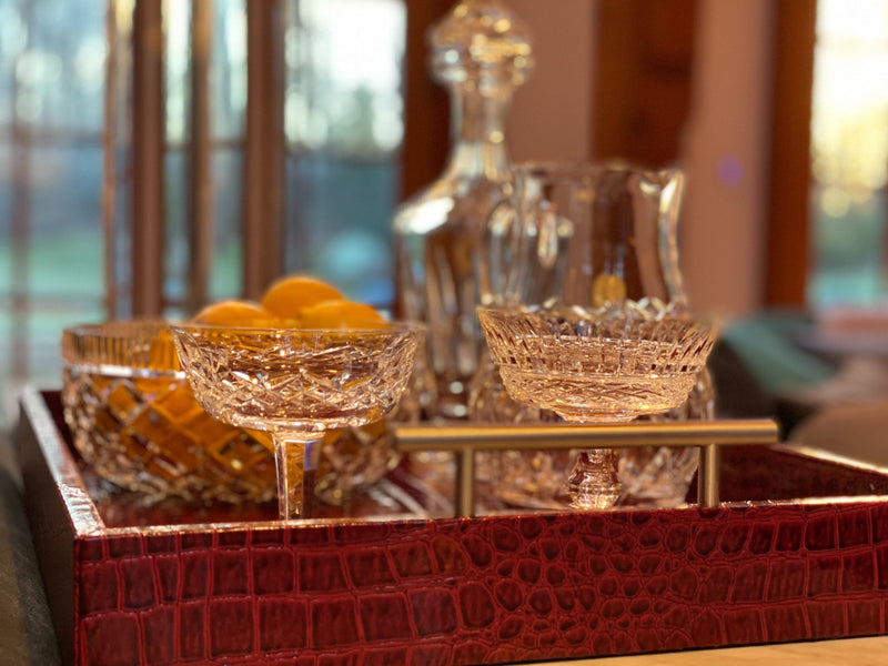 Discover the Pemberley Butler Red Leather Tray from One Preevay Luxury Home Furnishings—a masterpiece of sophistication and style. Handcrafted with embossed red crocodile leather, elegant nickel handles, and a luxurious black velvet underside, this tray is perfect for elevating your entertaining experience. Available in two spacious sizes, 15.8x15.8 inches and 19x14 inches, it combines exquisite craftsmanship with versatile functionality. Order now to indulge in the art of luxury entertaining....