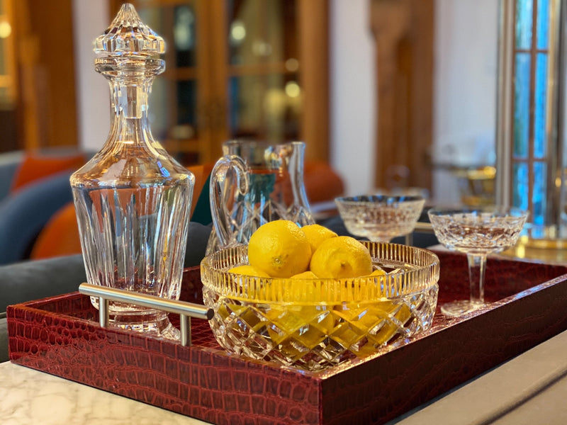 Discover the Pemberley Butler Red Leather Tray from One Preevay Luxury Home Furnishings—a masterpiece of sophistication and style. Handcrafted with embossed red crocodile leather, elegant nickel handles, and a luxurious black velvet underside, this tray is perfect for elevating your entertaining experience. Available in two spacious sizes, 15.8x15.8 inches and 19x14 inches, it combines exquisite craftsmanship with versatile functionality. Order now to indulge in the art of luxury entertaining....
