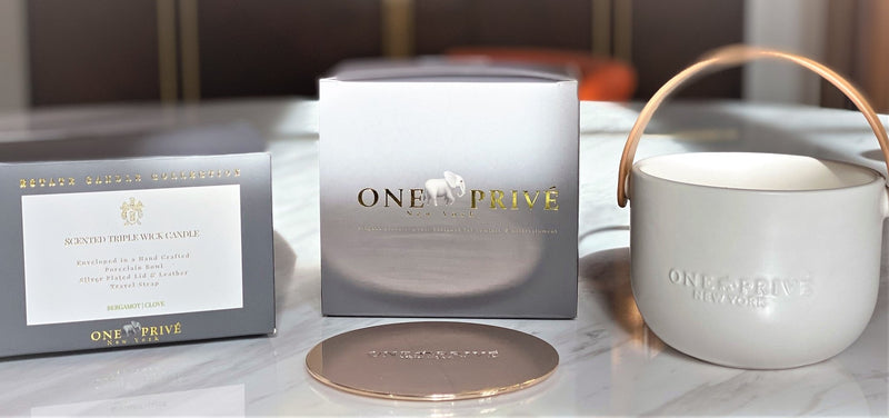 Indulge in the Bergamot and Clove Perfumed Estate Candle from One Preevay. Handcrafted with premium essential oils and soy wax, it features a stunning porcelain bowl with a silver-plated lid and leather strap. Elevate your ambiance with warmth