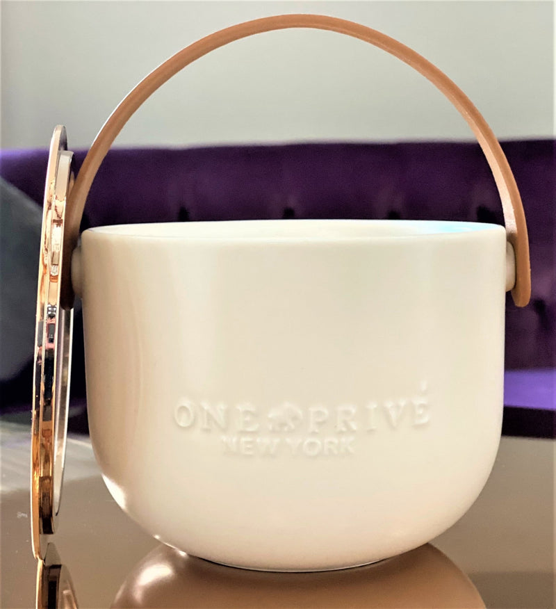 Indulge in the Bergamot and Clove Perfumed Estate Candle from One Preevay. Handcrafted with premium essential oils and soy wax, it features a stunning porcelain bowl with a silver-plated lid and leather strap. Elevate your ambiance today