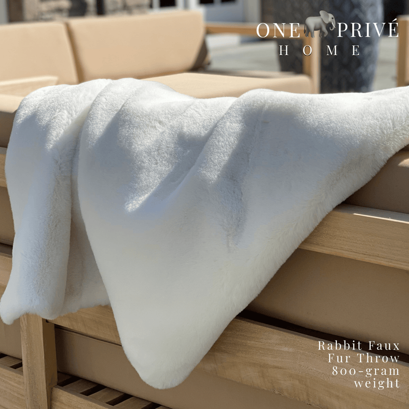 the One Preevay Faux Rabbit Fur Throw in Pure White. Inspired by the elegance of Fernando Botero and crafted from ultra-premium faux rabbit fur. Hypoallergenic, cruelty-free, over the sofa rolled...