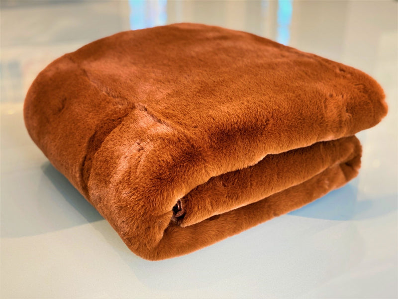 Experience luxury redefined with ONE Preevay's Faux Rabbit Fur Throw in Coco Brown. Inspired by Fernando Botero and crafted from Ultra Premium Faux Rabbit Fur. Hypoallergenic, cruelty-free, and lined with elegant velvet for refined warmth and sophistication. 800gsm, 50x60 inches