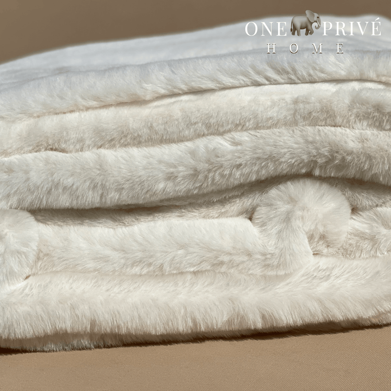  the One Preevay Faux Rabbit Fur Throw in Pure White. Inspired by the elegance of Fernando Botero and crafted from ultra-premium faux rabbit fur. Hypoallergenic, cruelty-free, over the sofa rolled 