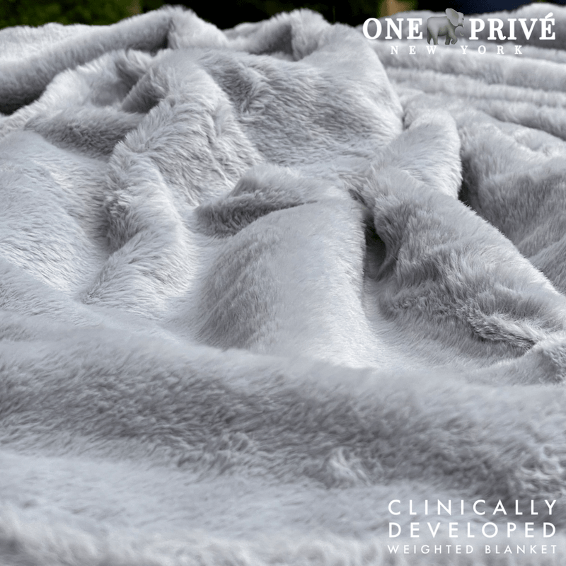 Experience luxurious relaxation with One Preevay's world's first weighted faux rabbit fur blanket, inspired by Fernando Botero. Clinically developed, 20lbs, hypoallergenic, and luxurious for serene sleep & relaxation always...
