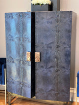 Experience ultra-luxury with One Preevay's bespoke Crocodile Armoire. Inspired by Louis XIV, this customizable piece combines elegance & functionality. Handcrafted with faux crocodile leather, ebony wood & marble handles. Starting at $7,500