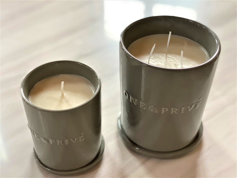 the Mediterranean Fig & Linen Perfumed Estate Candle from One Preevay. Handcrafted with essential oils and soy wax, it features a 21.2 oz pale gray ceramic vessel. Enjoy the fusion of figs, bergamot, lavender, Triple wick..